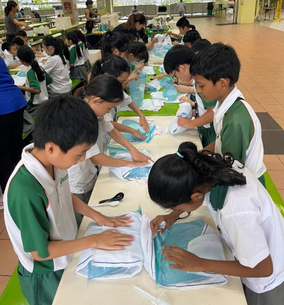 Students taking part in a hands-on learning activity in the classroom.